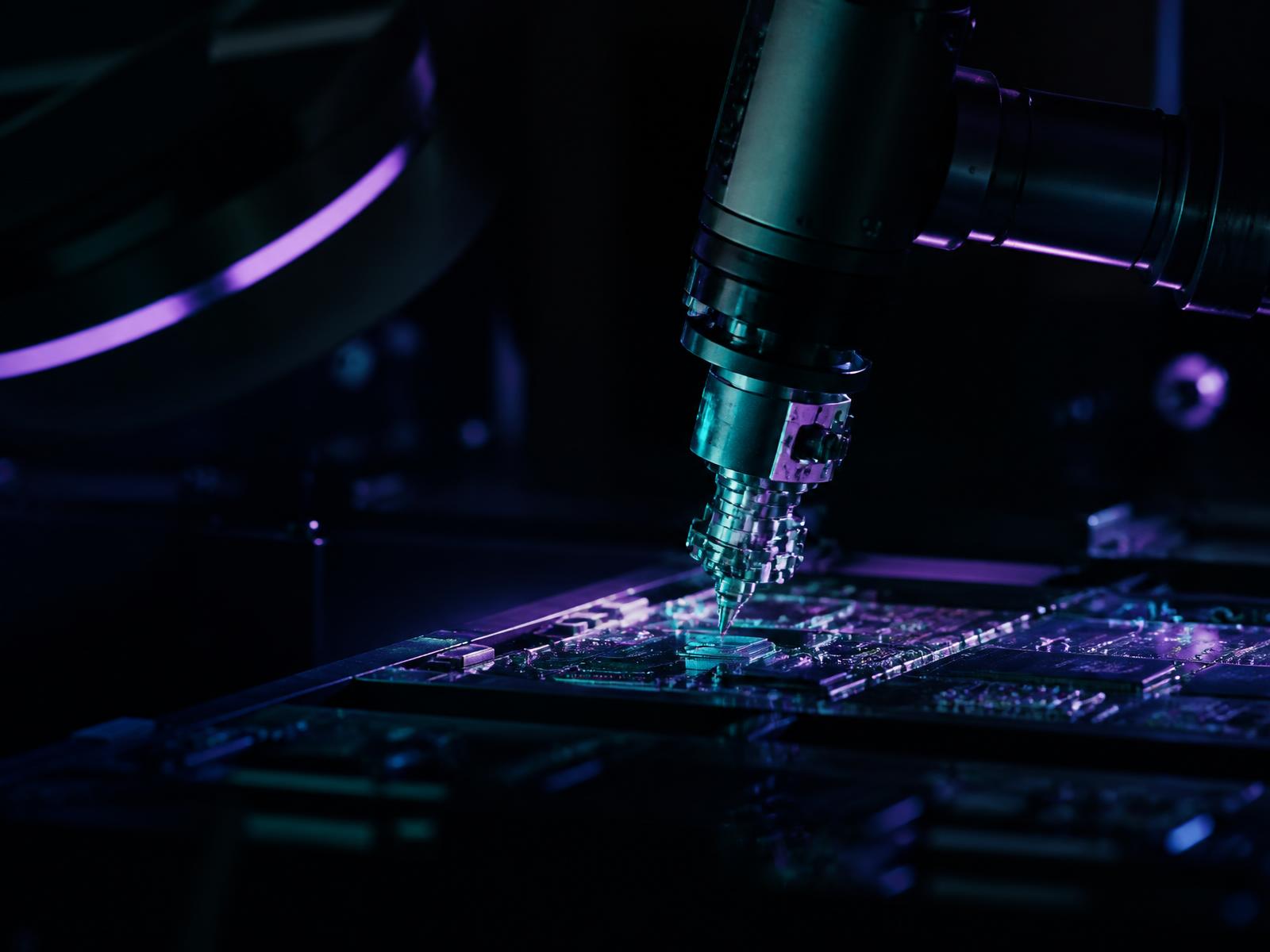 Robotic precision instrument working on a circuit board in a research laboratory